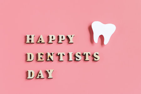 Paper cut mockup of tooth on pink background. Happy dentist day. Dental care concept.の写真素材