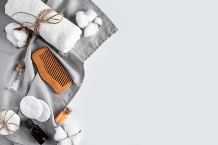 Set of natural cosmetics and spa accessories on white background. Towel, soap, hairbrush, essential oil. Face and body care concept. Beauty treatments, relaxation. Copy space.の写真素材