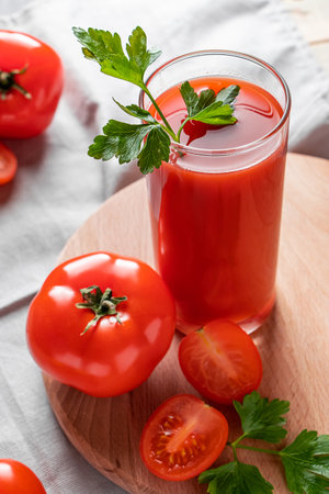 Fresh tomato juice on a wooden rustic background. Organic vegetable drink with parsley.の写真素材