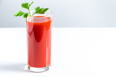 Glass with tomato juice on a white background.の写真素材