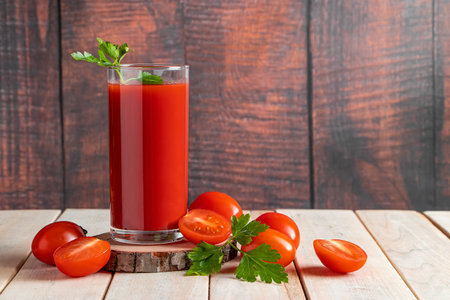 Fresh tomato juice on a wooden rustic background. Organic vegetable drink with parsley.の写真素材