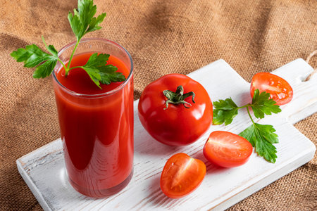 Dietary tomato juice on a linen background. Healthy drink made from farm vegetables.の写真素材
