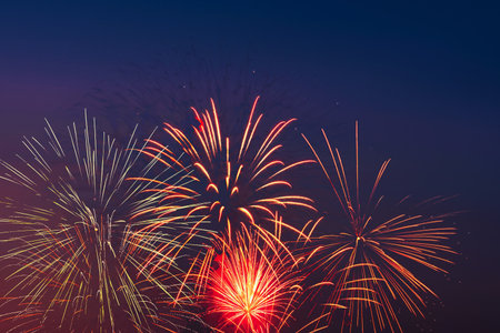 Bright colored fireworks on blue sky background. Celebration and holidays concept. New Year,...