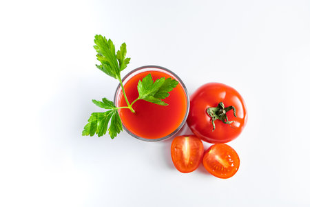 Glass with tomato juice on a white background.の写真素材
