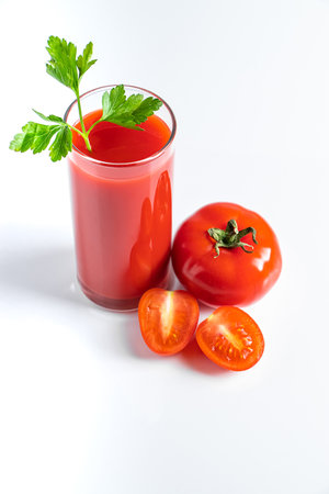Diet tomato juice with parsley on a white background. Vegan vegetable smoothie.の写真素材