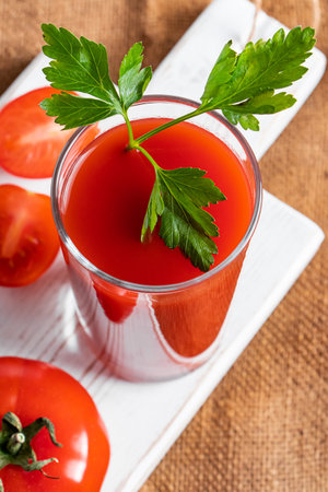 Dietary tomato juice on a linen background. Healthy drink made from farm vegetables.の写真素材