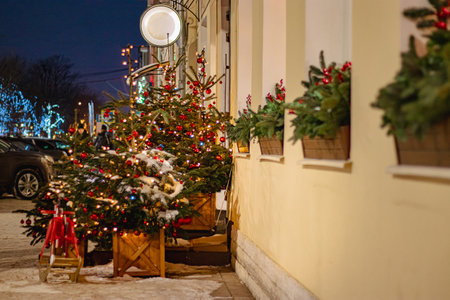 Christmas street decor. Festive trees with Christmas red balls. City decorations for New Year.の写真素材