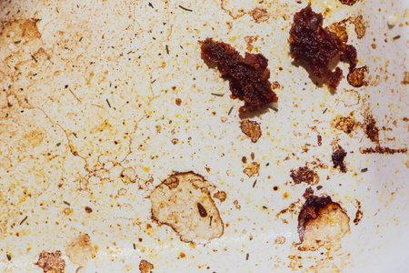 Texture of dirty stains and grease on white stove. Dried stains of fat on a white backgroundの写真素材