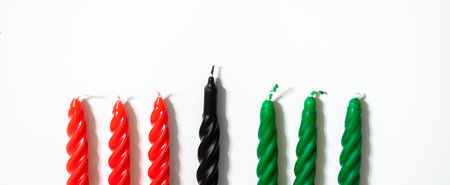 Happy Kwanzaa concept. Afro-American holiday. Seven candles - red, black and green. African heritage symbol on a white background. Banner formatの写真素材