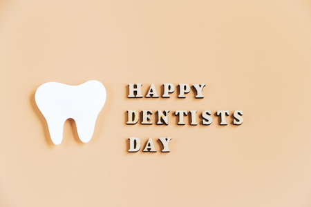 Happy dentists day. Eco-friendly wooden toothbrushes on trendy beige background. Dental care...