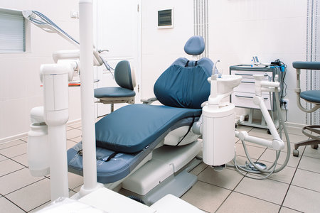 Modern dentistry clinic. Dental chair and tools for treatment and surgery of teeth. Dentist medical equipment. Empty dental office waiting for patient.の写真素材