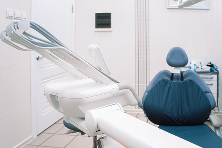 Modern dentistry clinic. Dental chair and tools for treatment and surgery of teeth. Dentist medical equipment. Empty dental office waiting for patient.の写真素材