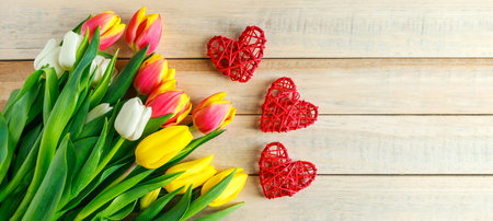 Tulips and heart on wooden background. Valentine's day greeting card concept. Banner formatの写真素材