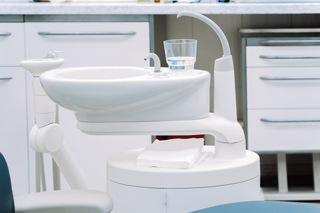 Modern dentistry clinic. Dental chair and tools for treatment and surgery of teeth. Dentist medical equipment. Empty dental office waiting for patient.の写真素材