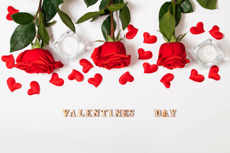 Bouquet of red roses, hearts and candles on white background. Valentine's day February 14. Place for your text.の写真素材