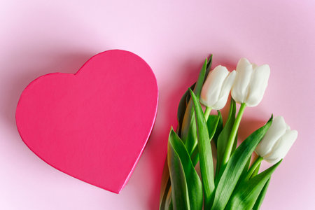 Valentine's day concept. Pink heart and white tulips. Greeting card, place for text.の写真素材
