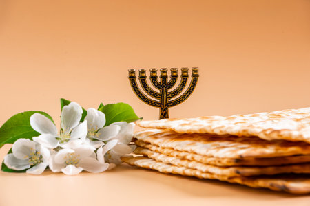 Happy Passover. Traditional Jewish menorah candlestick and matzo bread on beige background. Copy space.の写真素材