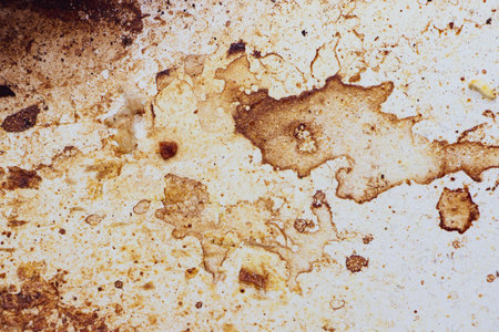 Texture of dirty stains and grease on white stove. Spots of fat on a white backgroundの写真素材