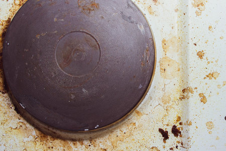 Dirt and grease on the white electric stove. Dirty kitchen after cooking.の写真素材