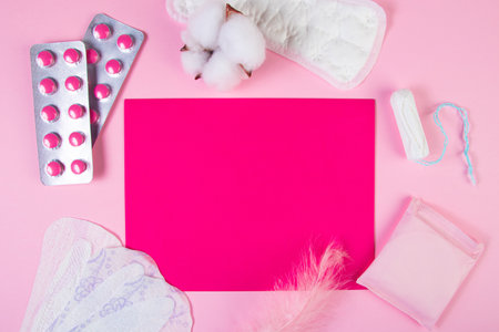 Set of feminine hygiene products for menstruation. Sanitary pads, tampons, pills on pink background. Womens health concept. Copy space.の写真素材