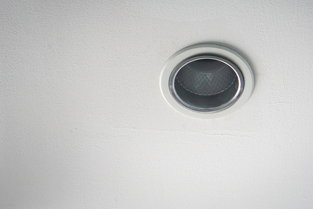 Round Spot lamp on a white wallの写真素材