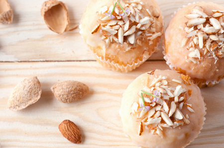 Cupcakes with almond crumbs on a light wooden table, top viewの写真素材