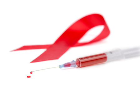 Red Ribbon AIDS syringe and a drop of blood on a white backgroundの写真素材