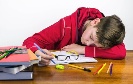 sleeping student performs homeworkの写真素材