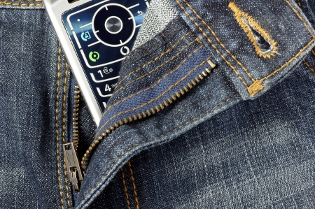 Cell phone between open jeans の写真素材