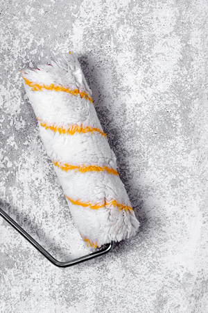 Paint roller on a concrete wall-primer,adhesive の写真素材