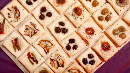 A closeup shot of a plate of mini tarts with raisins