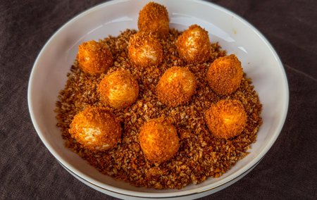 Close-up of taro balls with brown sesame seeds.