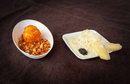 Thai dessert with coconut milk and coconut shavings on brown background