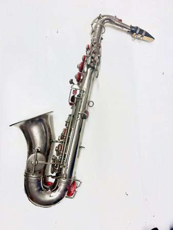 Saxophone on a white background, close-up, musical instrumentの写真素材