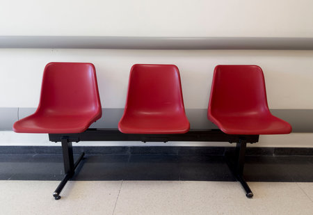 Row of red chairs in the waiting room, waiting for the train.の写真素材