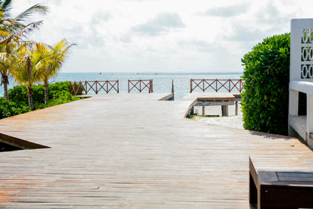 Wooden walkway on the beach with sea and sky background.の写真素材