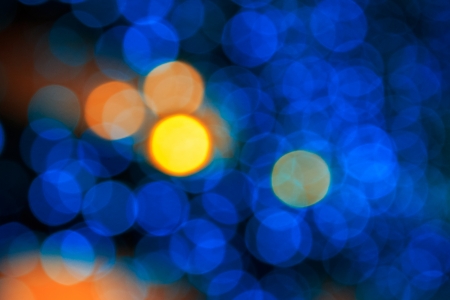 bokeh of yellow circle light on cool blue abstract blur の写真素材