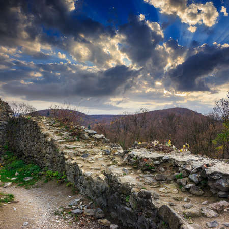 Stone wall of an old ruined castle in the mountainsの写真素材