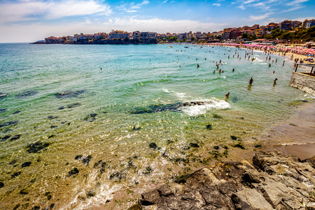 SOZOPOL - AUGUST 11: people on the sea beach on August 11, 2015 in Sozopol, Bulgaria. Sea beach full of people in high season in Bulgariaのeditorial素材