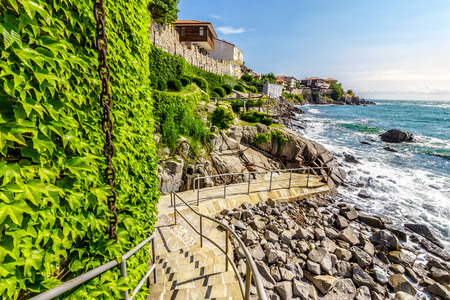 Ancient european city Sozopol on a rocky shore near sea in summer. piere and steps to sea shoreの写真素材