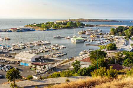 SOZOPOL - AUGUST 9: boats at sunset on August 9, 2015 in Sozopol, Bulgaria. boats and yachts docked near embankment in port of Bulgarian town Sozopol in evening lightのeditorial素材