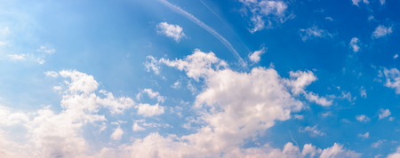 amazing cloud formations on a bright blue sky. beautiful side lit cloudscape panorama in springtimeの写真素材