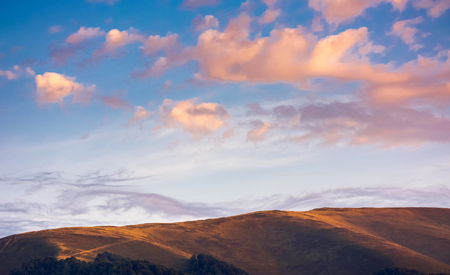 reddish cloudscape over the mountain top. beautiful nature background at sunset