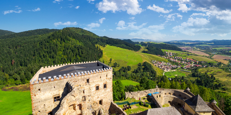 Stara Lubovna, Slovakia - AUG 28, 2016: view from the top of castle wall. beautiful rural landscape. village at the foot of the forested hillのeditorial素材