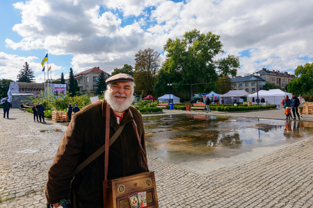 Uzhgorod, Ukraine - SEP 29, 2018: Czech days in TransCarpathia festival. people enjoy celebration of 100 year of Czechoslovakia declaration. Man with barrel organ smilingのeditorial素材