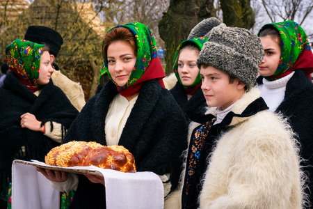 Uzhgorod, Ukraine - Jan 13, 2018: Vasylya festival celebrating in Museum of Folk Architecture and Life. local Romanians waiting for governor with traditional bread and saltのeditorial素材