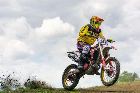 Uzhgorod, Ukraine - JUN 26, 2018: TransCarpathian Open Regional Motocross Championship. extreme sport competition. Accelerating in the mud. overcast sky