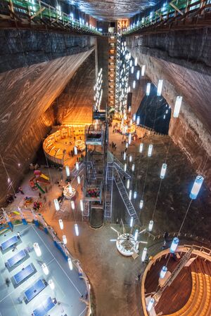 TURDA, ROMANIA - APR 30, 2018: Hall of Salt Mine Salina Turda museum. popular travel destination. underground place with ferris wheel, tennis courts and opera.のeditorial素材