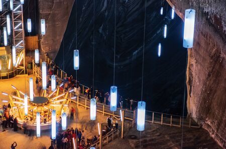 TURDA, ROMANIA - APR 30, 2018: Hall of Salt Mine Salina Turda museum. popular travel destination. people looking in to the pitのeditorial素材