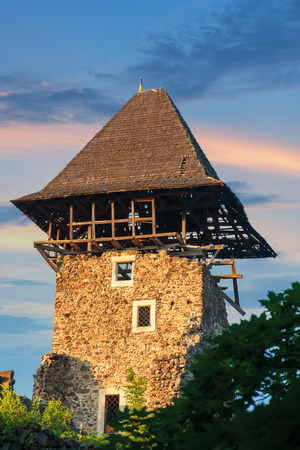 tower of Nevytske Castle in evening light. detail of the popular transcarpathian landmark. beautiful scenery on the background of wonderful sky at sunsetのeditorial素材